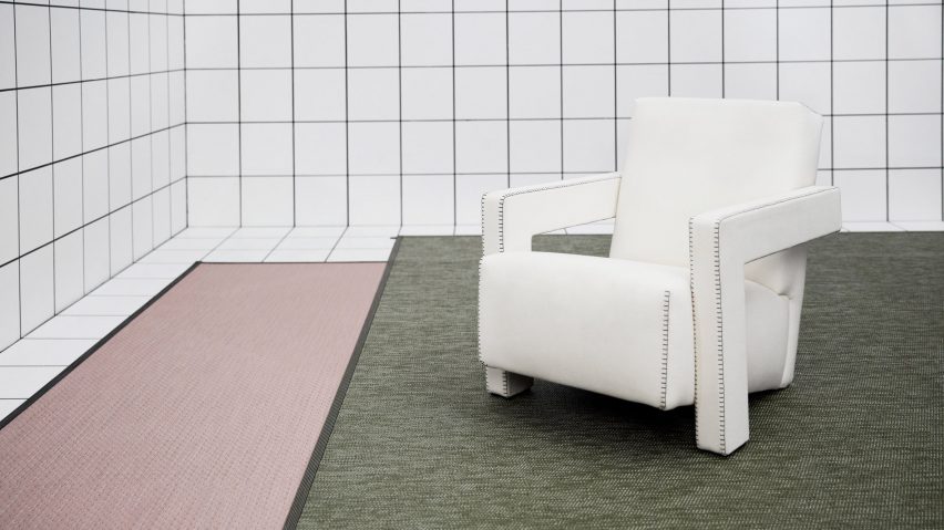 A white room with pink and green rugs
