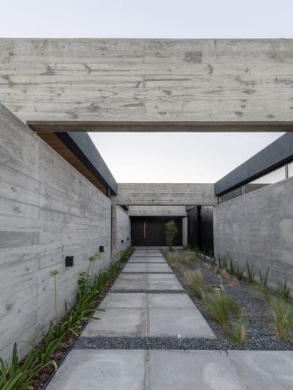 Intersecting concrete slabs lead to front door