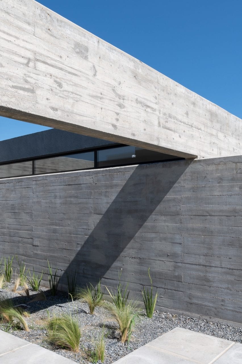 Intersecting concrete slabs forming house