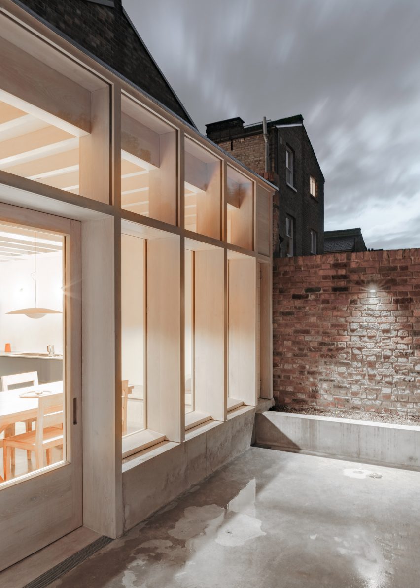 The extension has a light concrete exterior