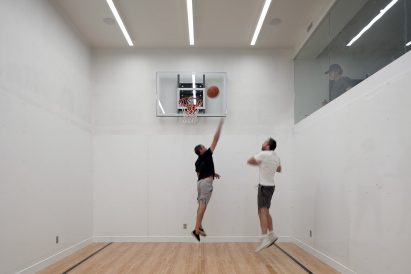 Drew Mandel Architects designed a basketball court in the basement