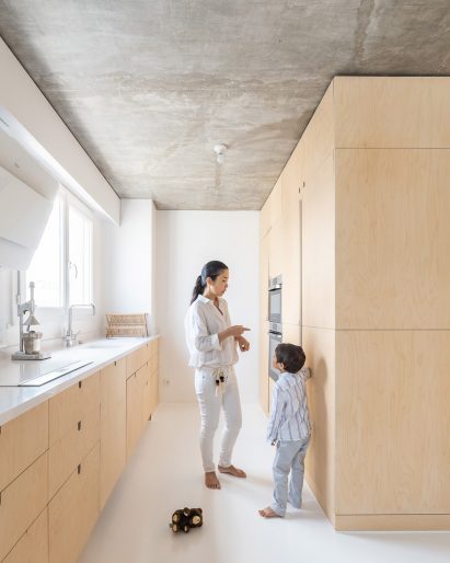 Wood covers the cabinetry at Sacha apartment by SABO project
