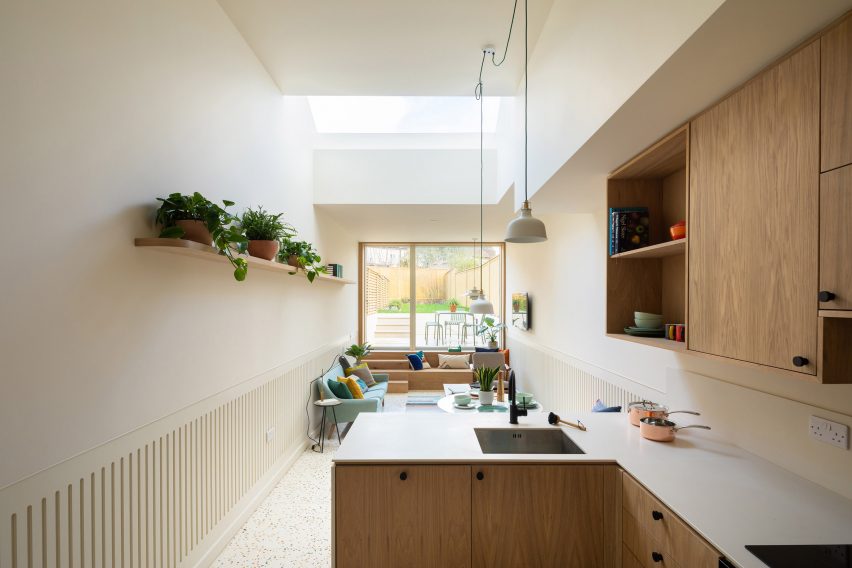 A white-walled kitchen with wooden cabinets
