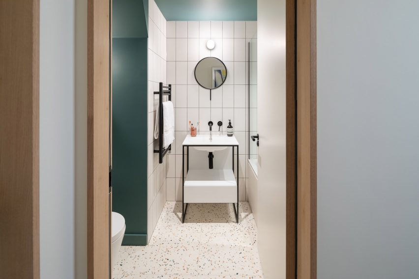 A green and white-tiled bathroom
