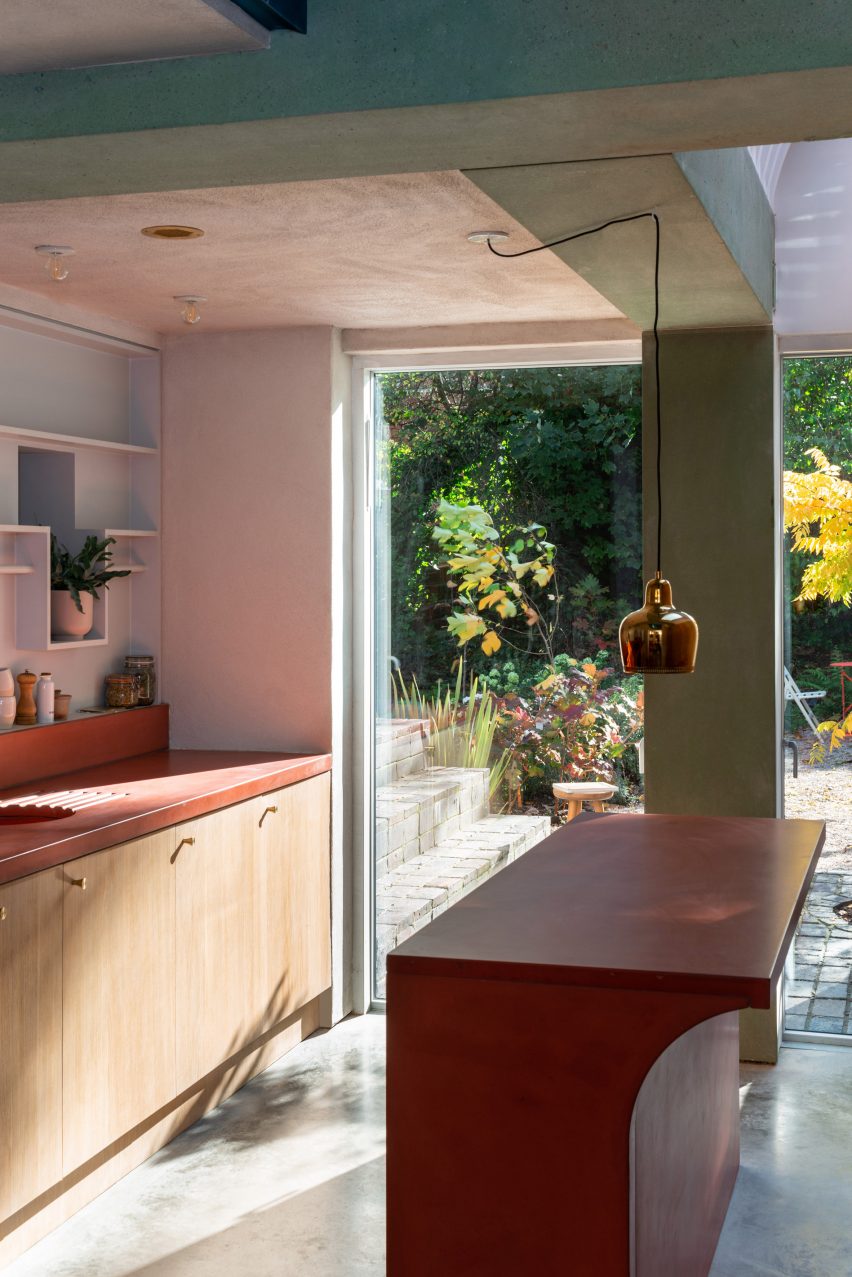 The kitchen has a red island