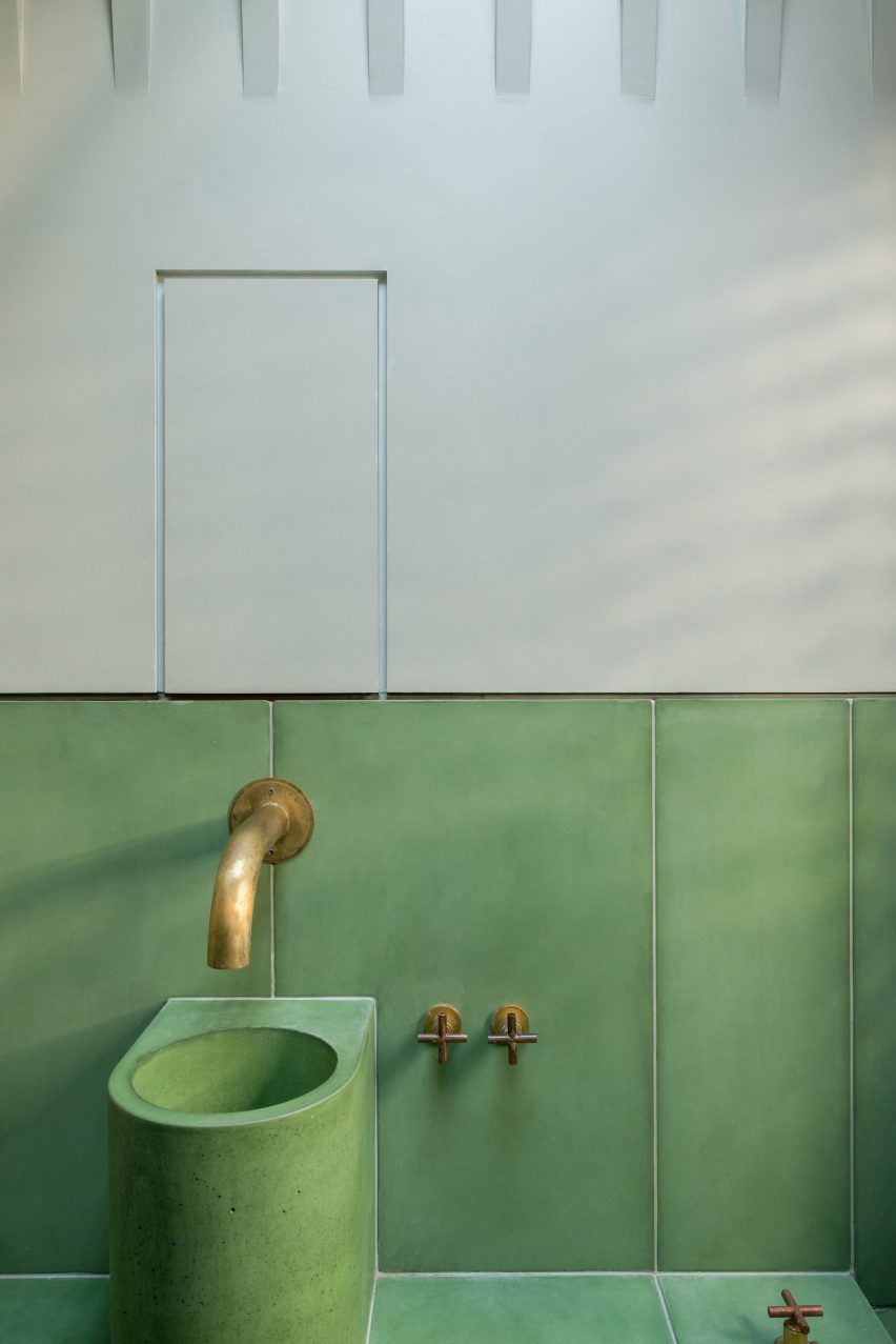 Green tile panels cover the walls