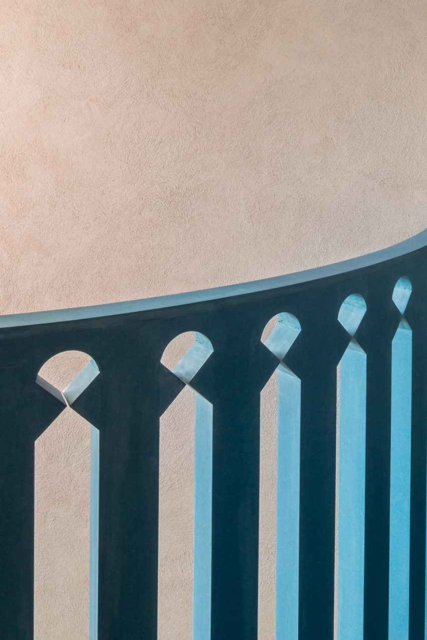 A blue balustrade has a geometric design