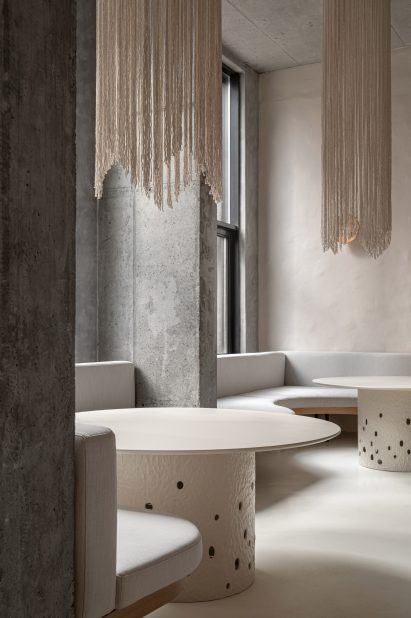 Undulating seating area with round tables in Istetyka restaurant