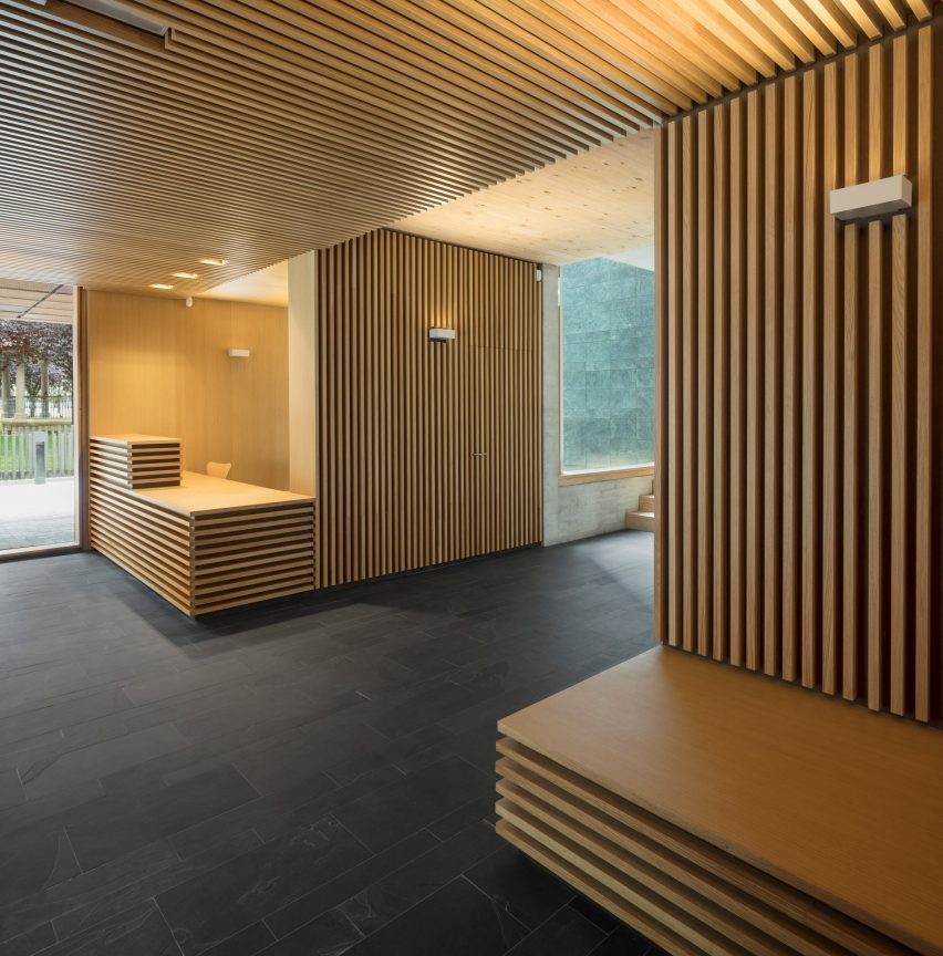 Seating and desks are clad in wood batons