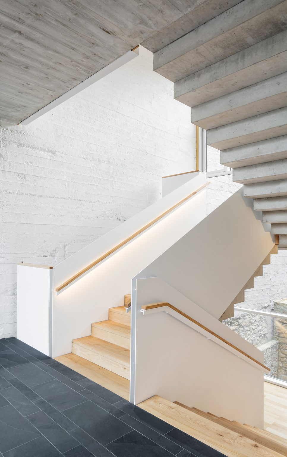 Staircases have a light wood finish