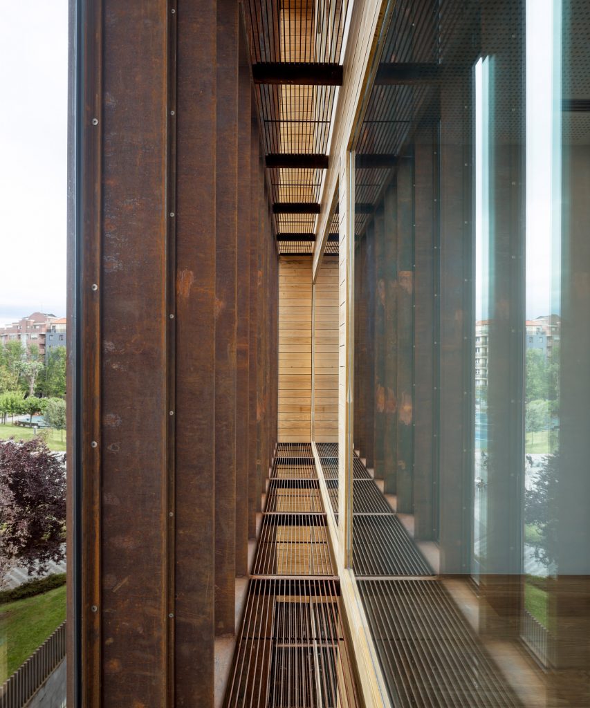 The steel wraps around the glazed building