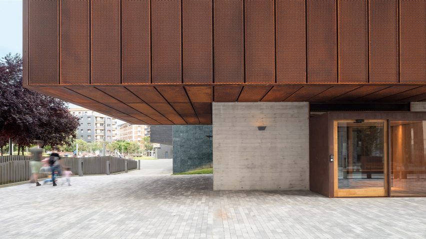 Concrete at the base meets weathered-steel