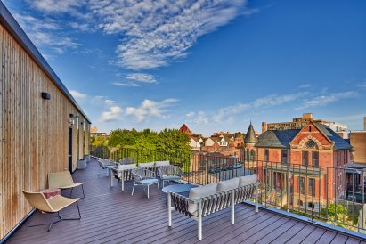 A communal terrace overlooks a vast Victorian mansion