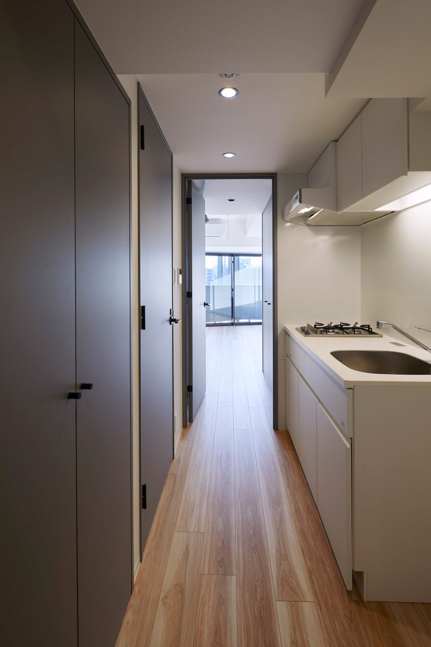 A galley kitchen is located between living spaces