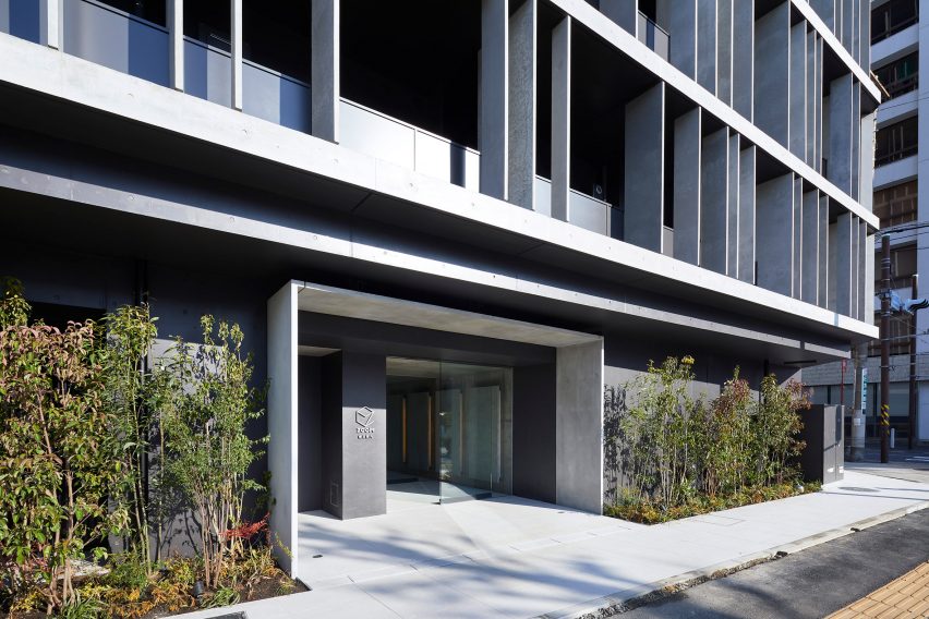 The entrance to the building is marked by greenery