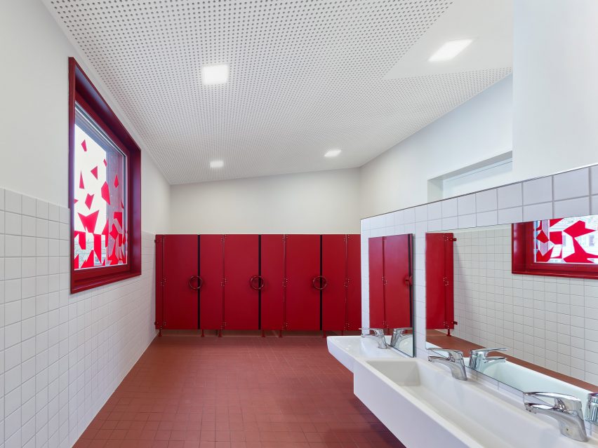 The bathroom has a red and white finish