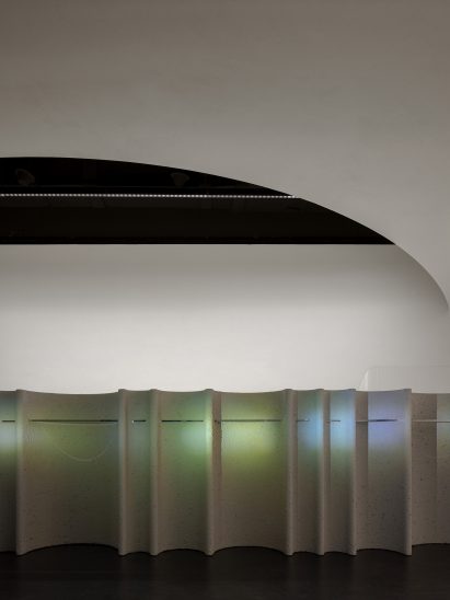 Colourful lights on grey display units in skincare store