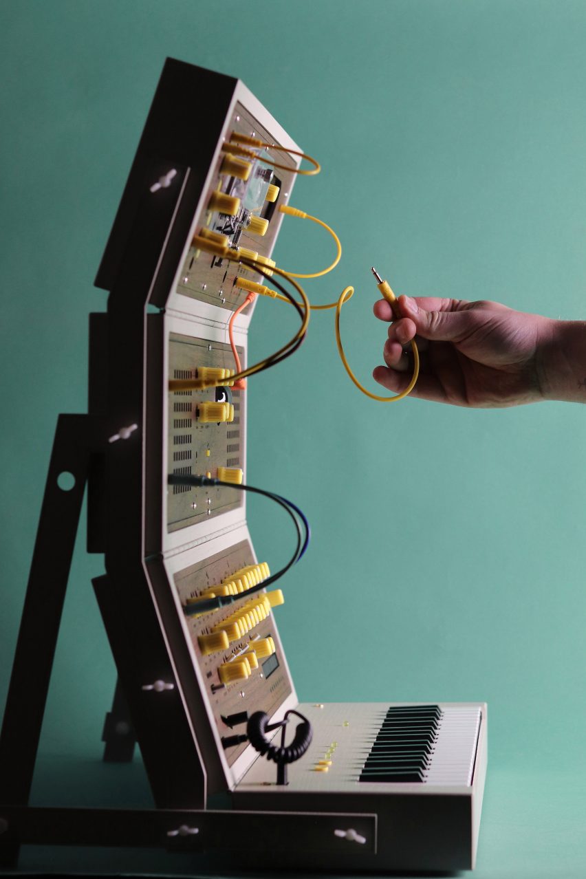 Hand connected a cable on a custom modular synthesiser