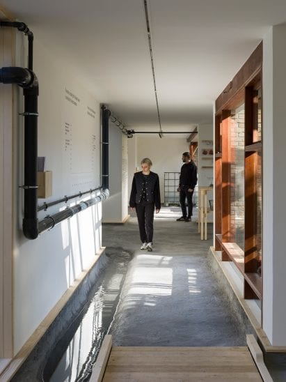 A stream flows through the Danish Pavilion