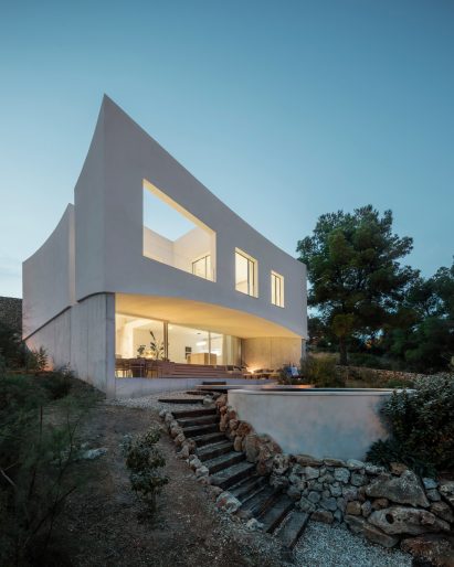 Curved House is surrounded by greenery