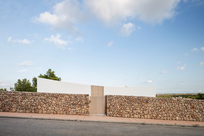 The home is surrounded by a brick wall