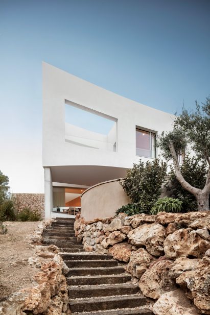 Steps in the garden lead up to Curved House