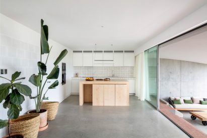Glass sliding doors at Curved House lead to the outdoors