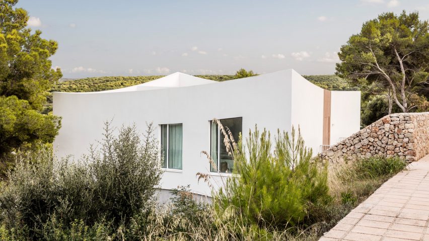 The home is nestled between greenery