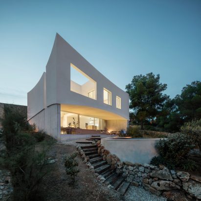 Nomo Studio carves curved patios and terraces into Menorcan holiday home