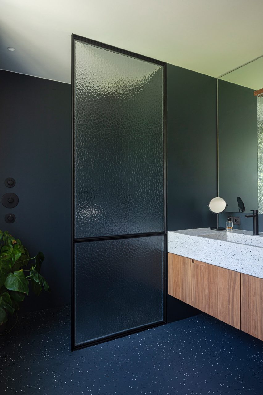 The bathroom has a dark finish