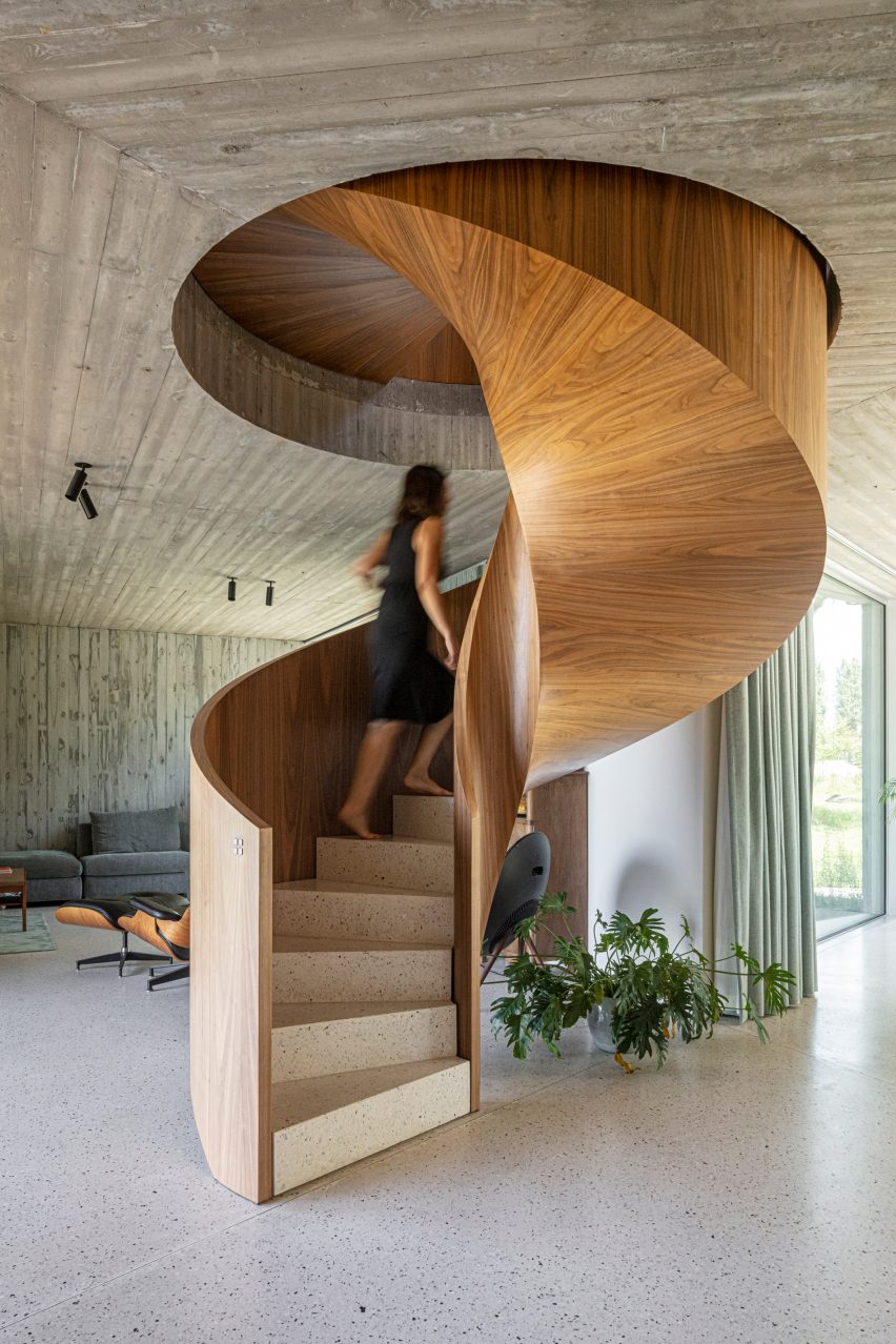 The staircase has a warm wood finish