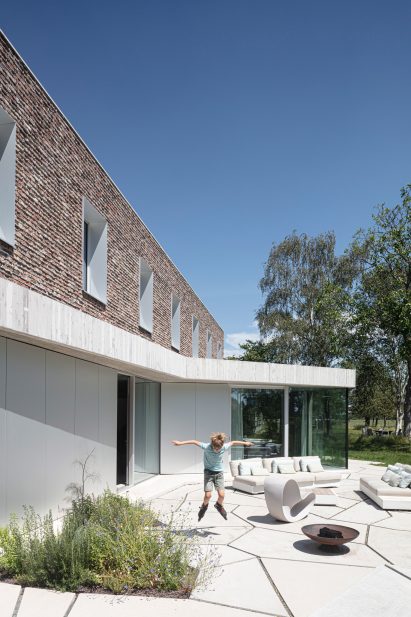 Geometric shaped paving covers the floor of the garden at House Dede