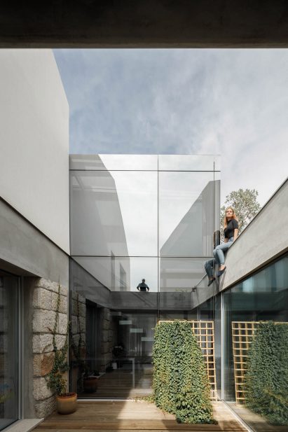 A glazed wall of Casa Rio reflects its surroundings