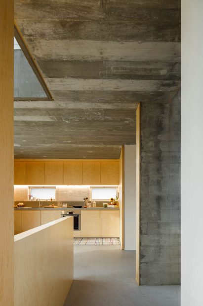 Concrete and light wood are combined in the kitchen