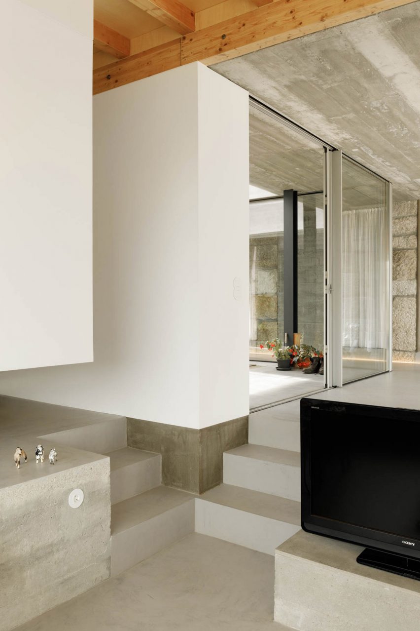 Concrete steps lead into the sunken living space
