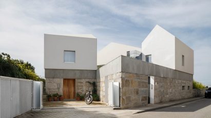 The home has a stone and white rendered exterior