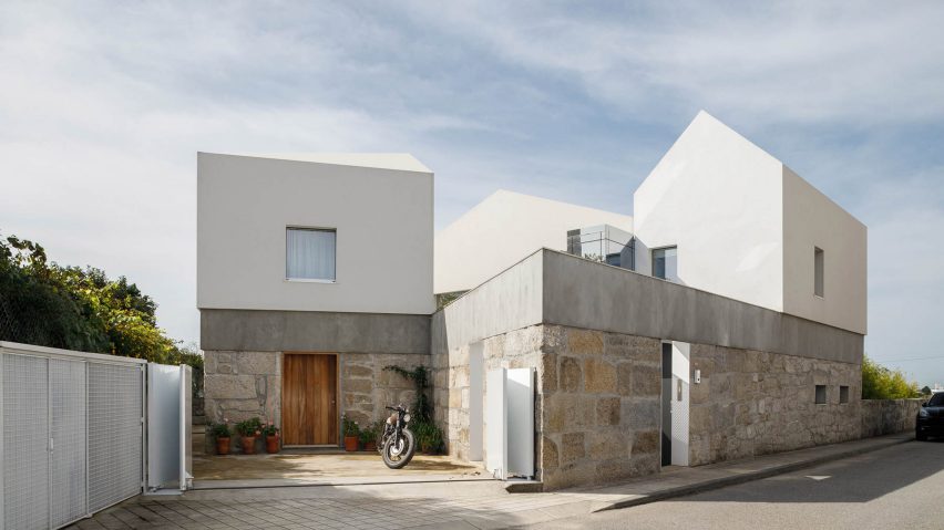 The home has a stone and white rendered exterior