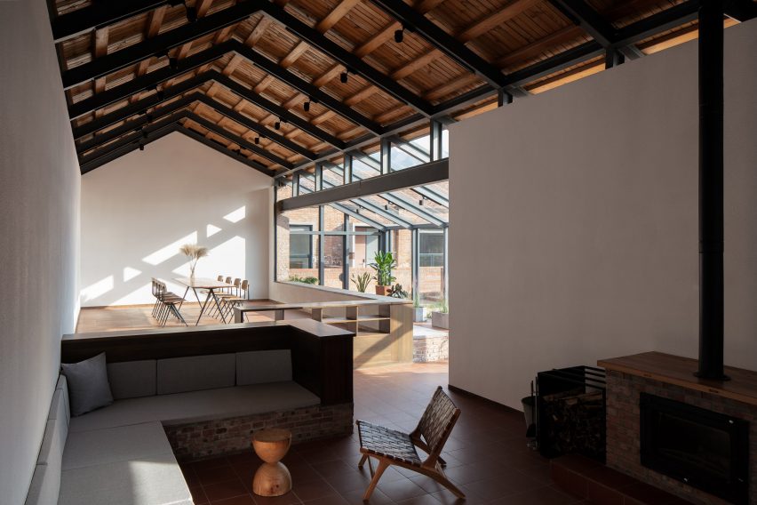A living room with a wooden vaulted ceiling