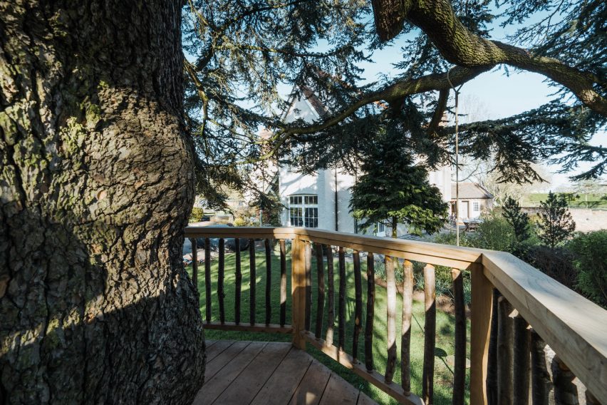 Balcony of a treehouse looking out onto the main house