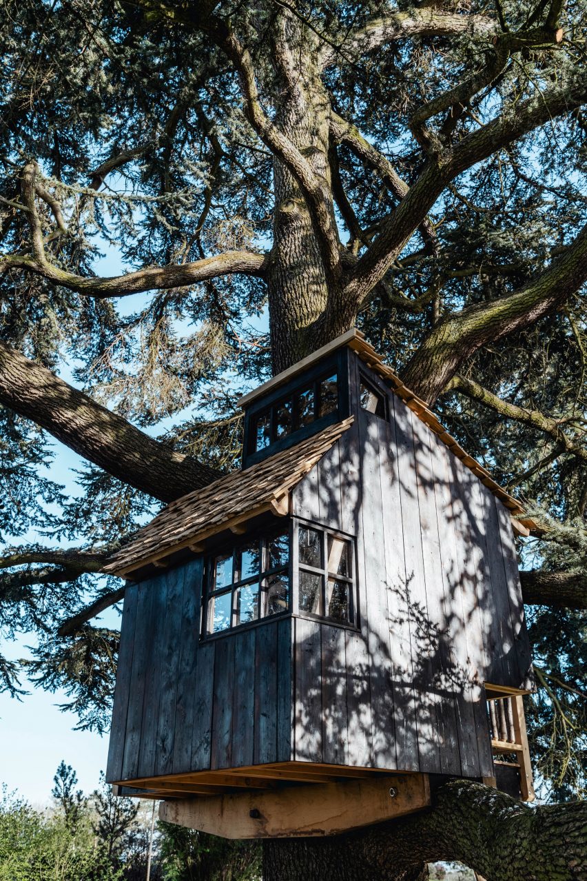 Scorched-larch treehouse on cantilevered beams