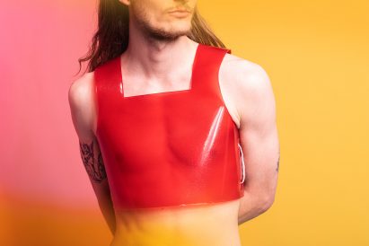 Person wearing shiny red vest top by Valdís Steinarsdóttir
