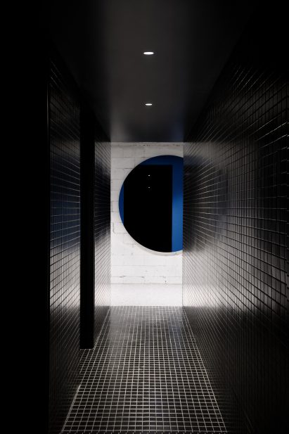 Bathrooms have black tiles and pops of colour