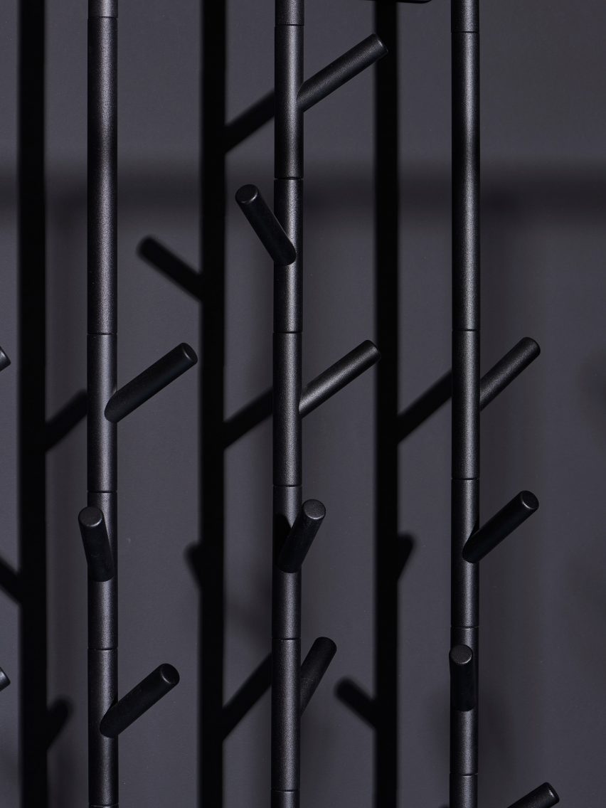 Branch-like hooks on a black coat stand