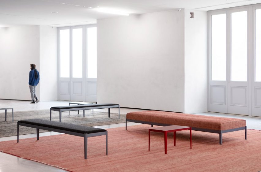 Red and black furniture sit atop rugs