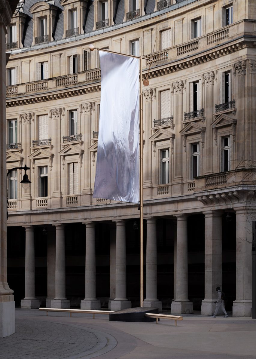 A silver flag pole was built within a rock