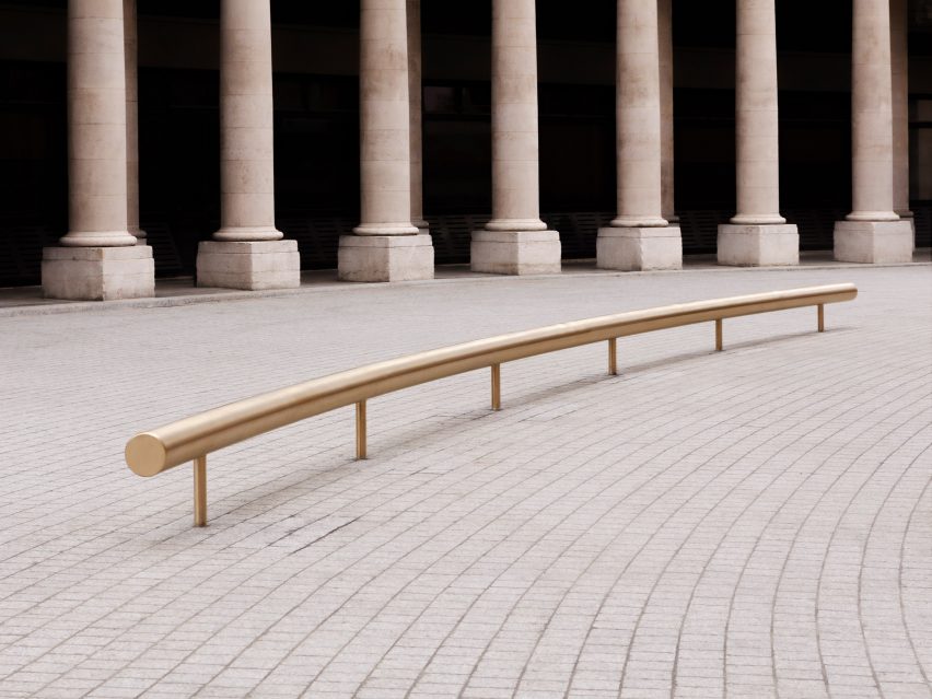 A tubular metal bench is located outside