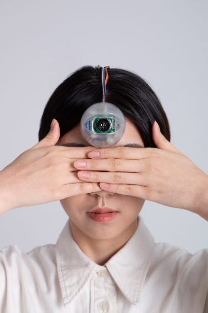 Woman wears Third Eye prosthetic on her forehead