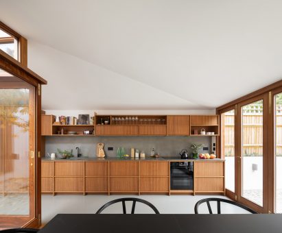 A wooden kitchen that stretches the length of a wall