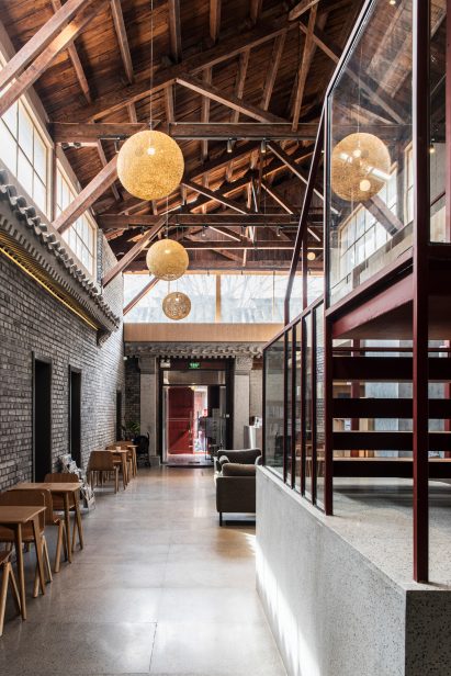 Interior courtyard with wooden roof and clerestory windows windows in Well Well Well Hotel