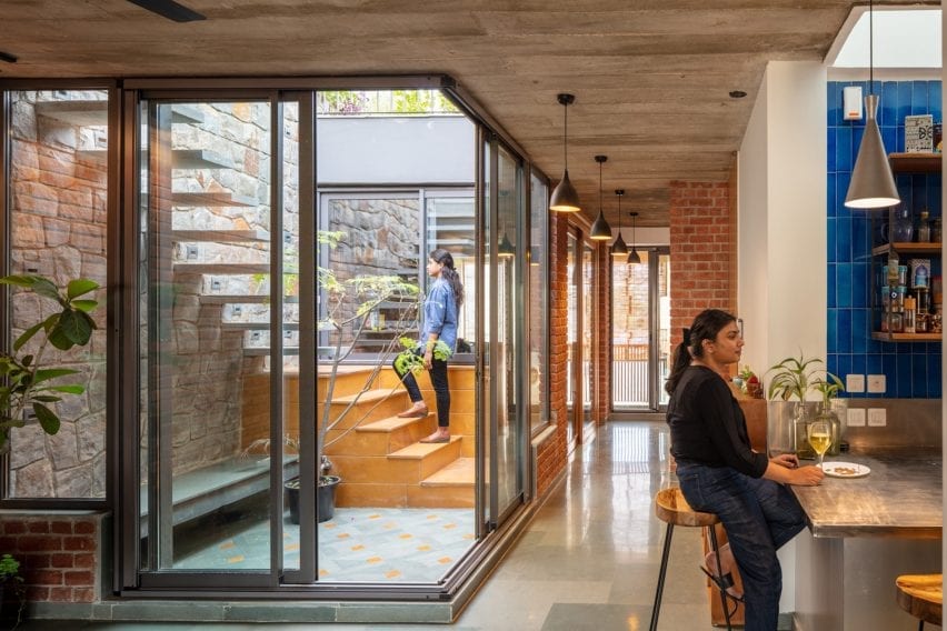 An internal courtyard has glass walls